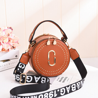 

Fashion rivet small round bag portable Korean version of the lady bag shoulder diagonal wide shoulder strap small bag