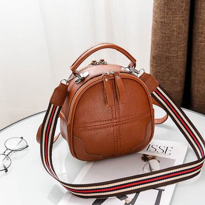 

A girl with a double shoulder bag a broadband shoulder bag a Korean version of a backpack a girl slanted a small round bag and