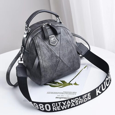 

A girl with a double shoulder bag a broadband shoulder bag a Korean version of a backpack a girl slanted a small round bag and
