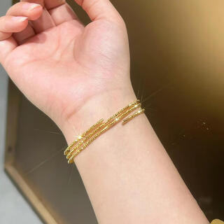 Mu shen's new niche designer bracelet with elastic beads wrapped around three times and stacked with flashes of broken gold. three lives and three worlds.