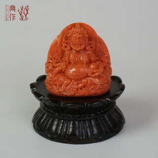 A classic collection of natural taiwan momo red coral master-carved yellow god of wealth statues and ornaments