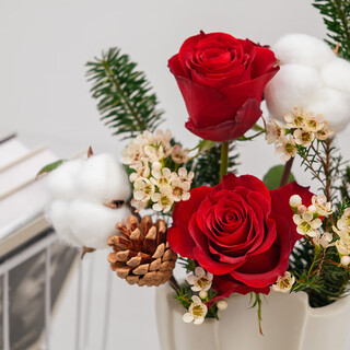 The first snow in winter, roses and pine cones mixed flowers are perfect for christmas