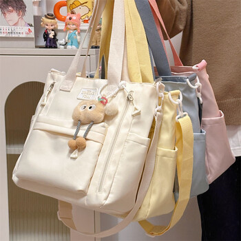 Rui chao simple and versatile commuter tote bag large capacity shoulder bag girl handbag student tutoring class diagonal school bag white long leg biscuit pendant