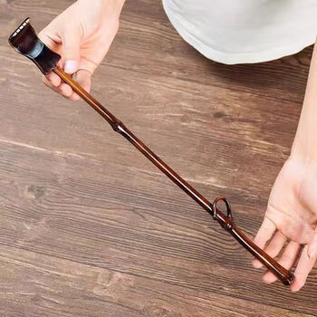 Itching and scratching tool. the old man is happy to scratch his back and scratch his natural bamboo. the lacquered bamboo branch scratches his back.