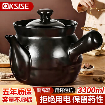 Sister-in-law jin decoctions the medicine in a casserole and boils the chinese medicine jar. open fire ceramic medicine pot. the chinese medicine pot boils the medicine in the casserole.