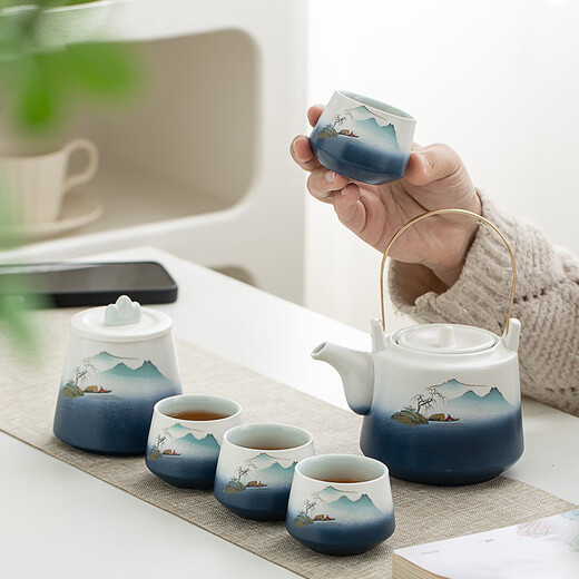 Gold inlaid jade Kung Fu tea set, a complete set of ceramic lifting kettles, tea cups, tea cans, Kung Fu tea sets, souvenirs, scenic blue and white lifting sets