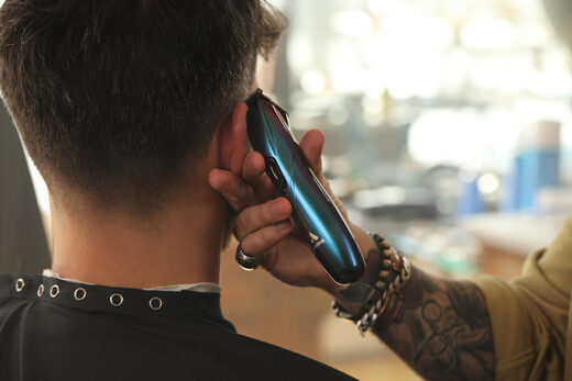 Andis professional cordless T-shaped hair trimmer for precise shaving and 2-hour battery life