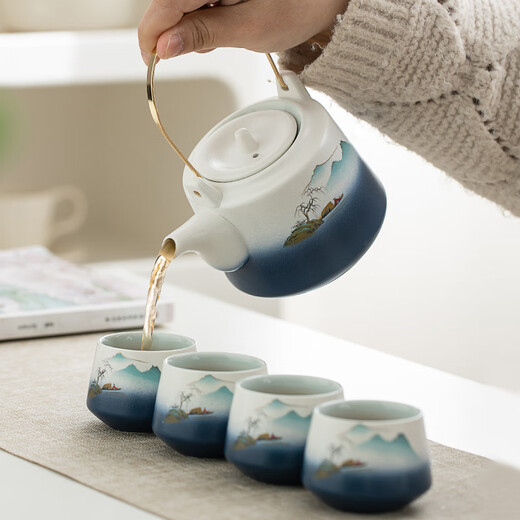Gold inlaid jade Kung Fu tea set, a complete set of ceramic lifting kettles, tea cups, tea cans, Kung Fu tea sets, souvenirs, scenic blue and white lifting sets