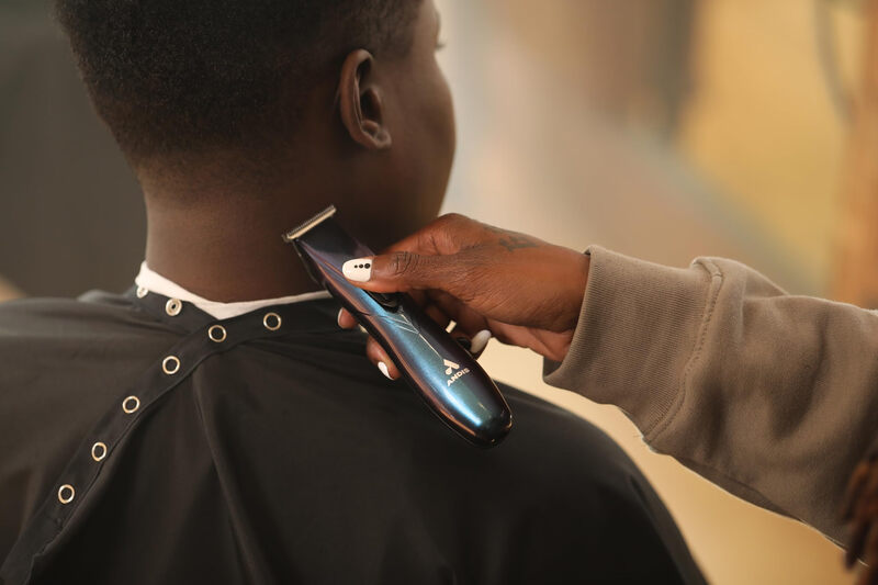 Andis professional cordless T-shaped hair trimmer for precise shaving and 2-hour battery life