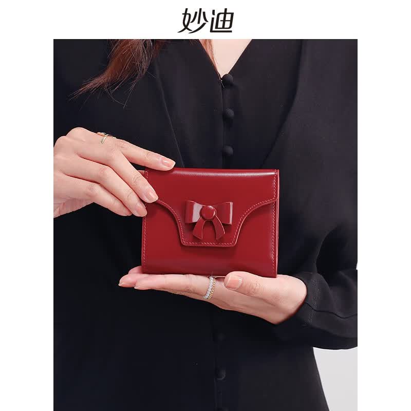 妙迪（mood）真皮新款蝴蝶结牛皮精致短款折叠女士零钱包卡包 冰晶车厘子【牛皮】属于什么档次？